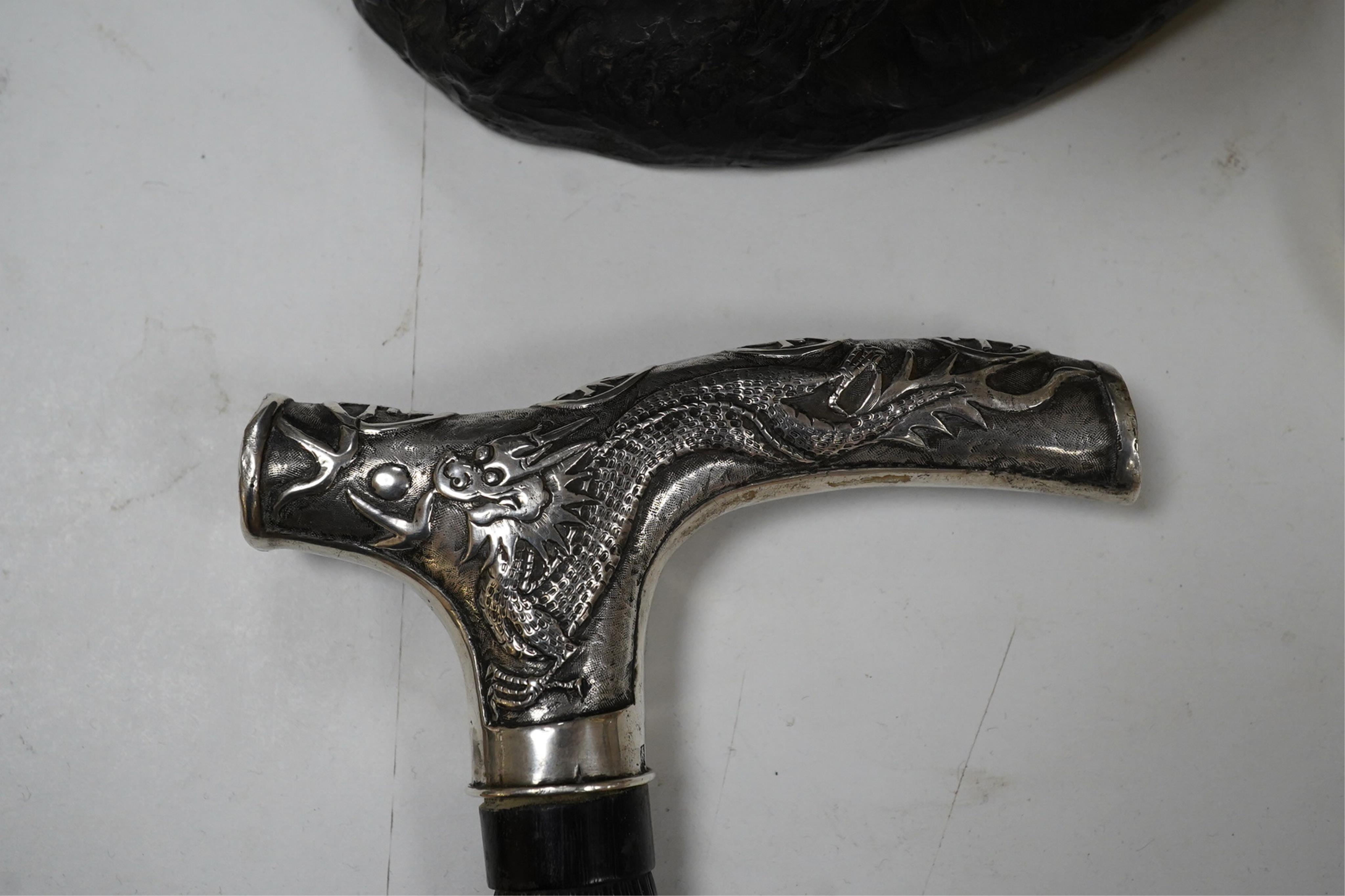 A 19th century Chinese export silver ‘dragon’ handled carved ebony walking cane, handle signed, 81cm long. Condition - fair to good